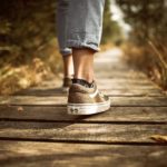 negative-space-sneakers-walking-wood-path-tobi