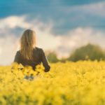 neagtive-space-woman-in-yellow-field-at-sunset